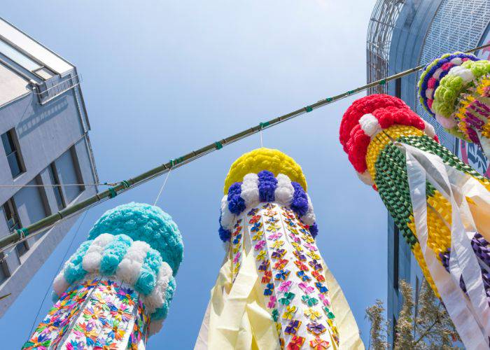 Looking up at the decorations of the Sendai Tanabata Festival in Miyagi, set against a clear, blue sky.